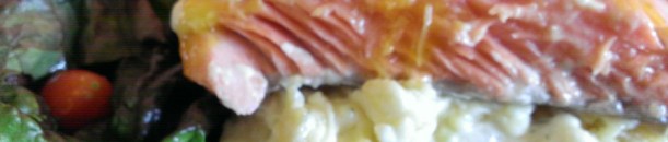 Medium rare coho salmon over potatoes with green salad. Photo by Ria Loader